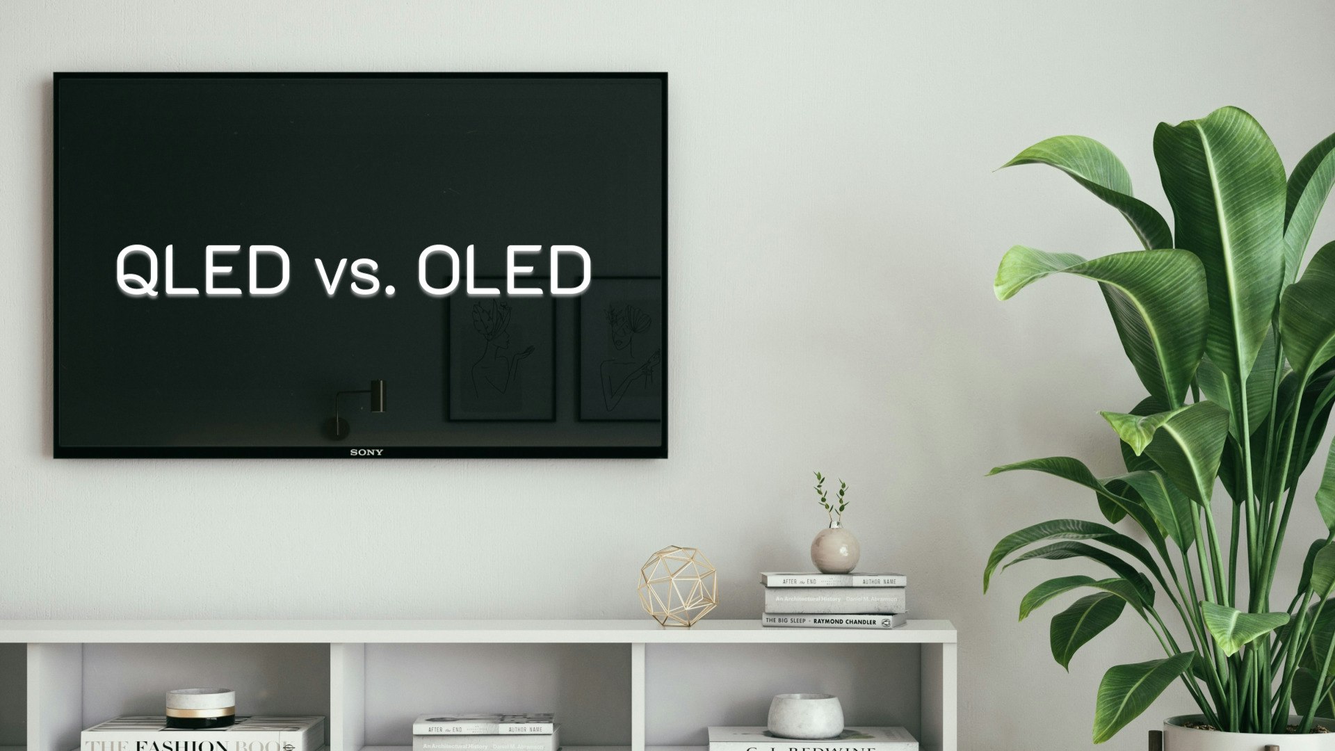TV with "QLED vs. OLED" text displayed on the screen