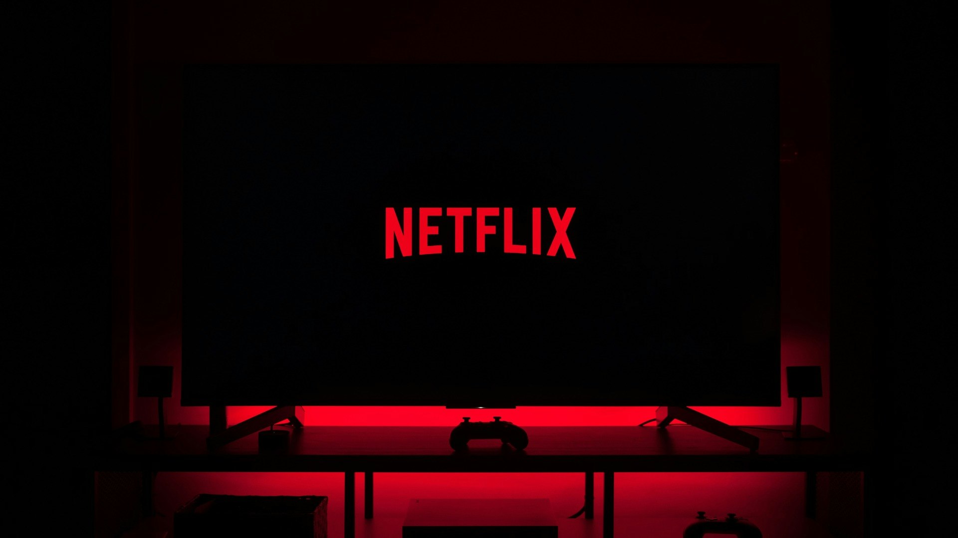 Dark room with Netflix logo on TV